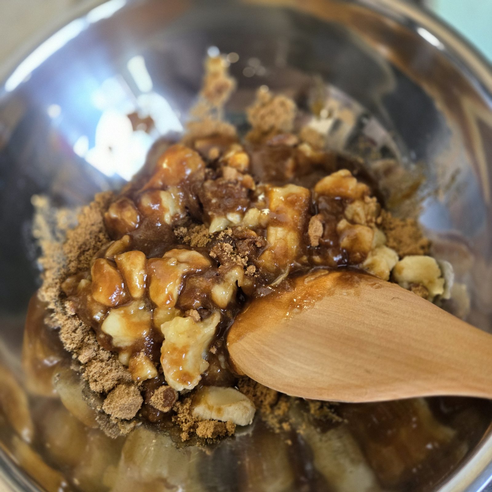 Mashed banana and brown sugar being mixed in a bowl